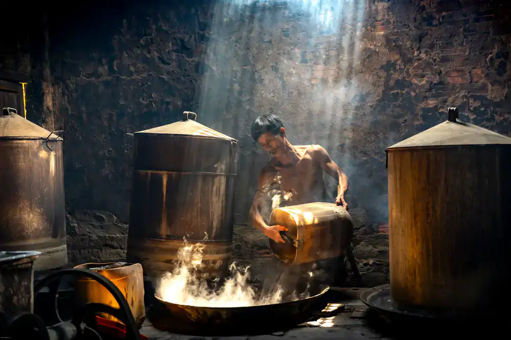 Distiller working with the copper still